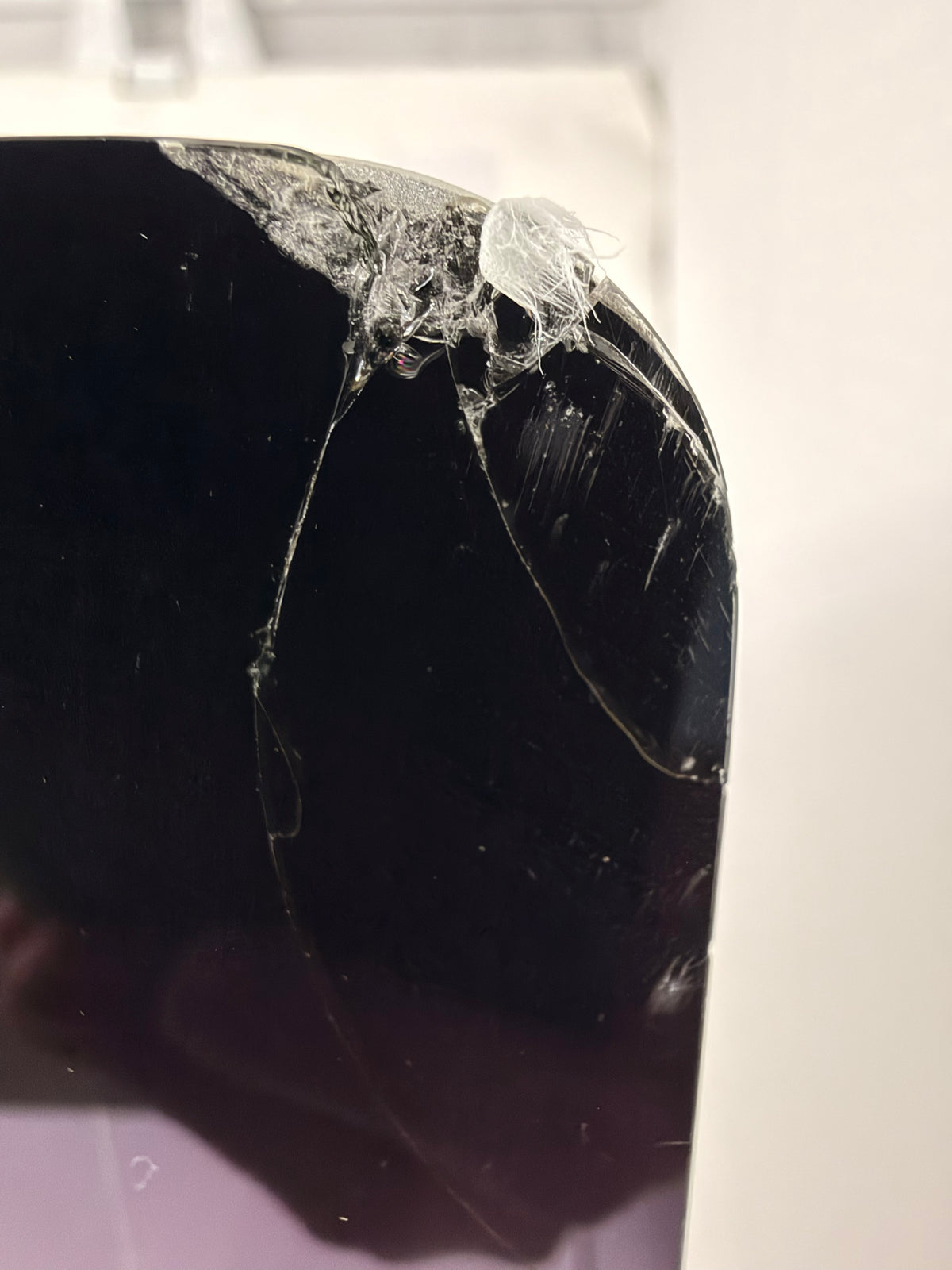 Close-up of shattered glass at the iMac's top-right corner