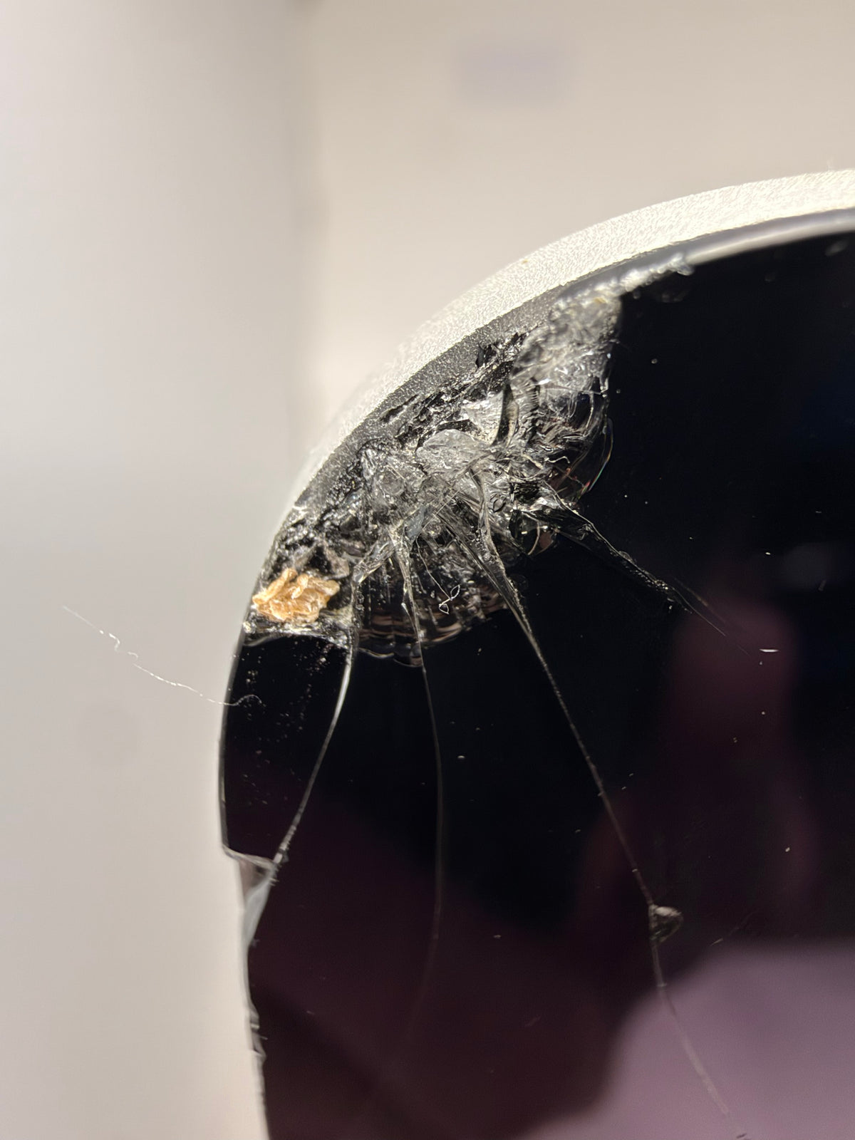 Close-up of shattered glass at the iMac's top-left corner